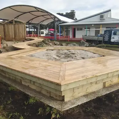 Timber-framed sandpit with surrounding deck and boardwalk at Totara Grove School, Whangarei