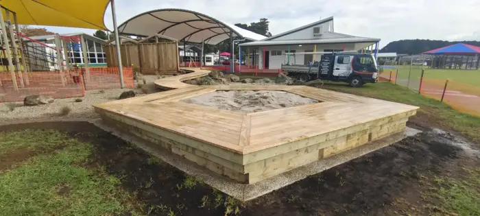 Timber-framed sandpit with surrounding deck and boardwalk at Totara Grove School, Whangarei
